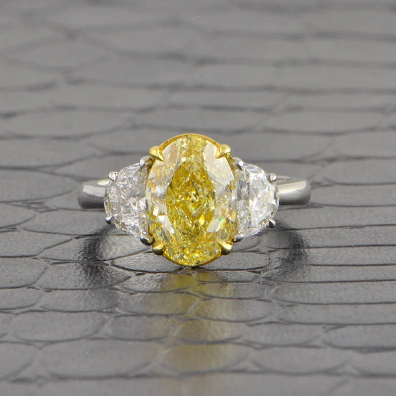 Shine Bright With Our Special Jewelry Promotions Fancy Light Yellow Oval Cut Diamond Ring in Platinum