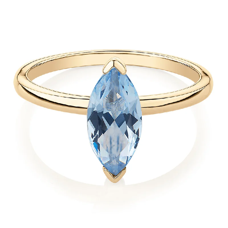 Affordable Luxury Jewelry For Every Occasion Dress ring with aquamarine simulant in 10 carat yellow gold