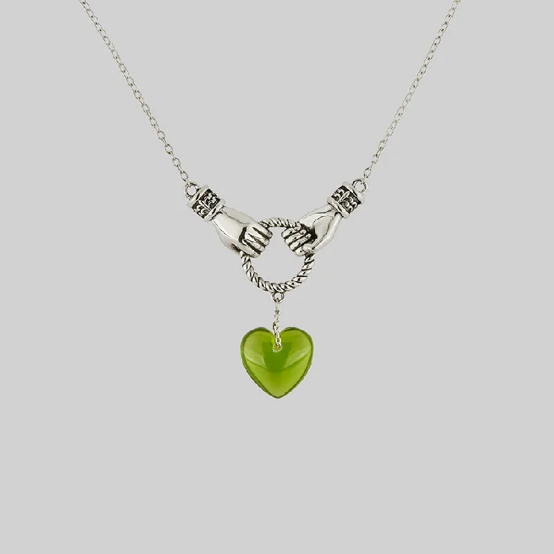 Don't Miss These Dazzling Jewelry Discounts UNITE. Hand Grasping Green Glass Heart Necklace - Silver