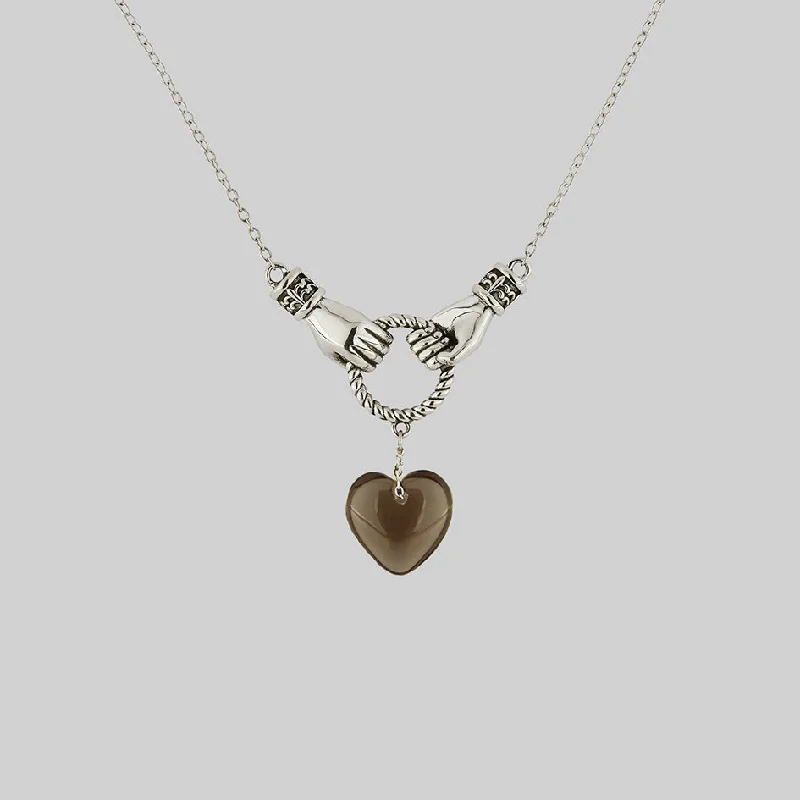 Jewelry Deals That Outshine The Rest UNITE. Hand Grasping Smoke-Black Glass Heart Necklace - Silver